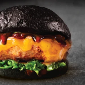 The BRGR's black pepper grilled chicken burger with melted cheese, fresh lettuce and charcoal black bun